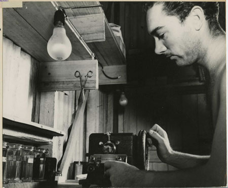 otis-microtome Pvt. Fred L. Walling. Operating a microtome, which is used for cutting thin sections of tissue and bone; these thin sections are placed on microscope slides and are used for the diagnosis of the cause of death. New Guinea. 02/16/1943.